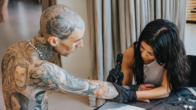 Travis Barker gets tattooed by Kourtney Kardashian