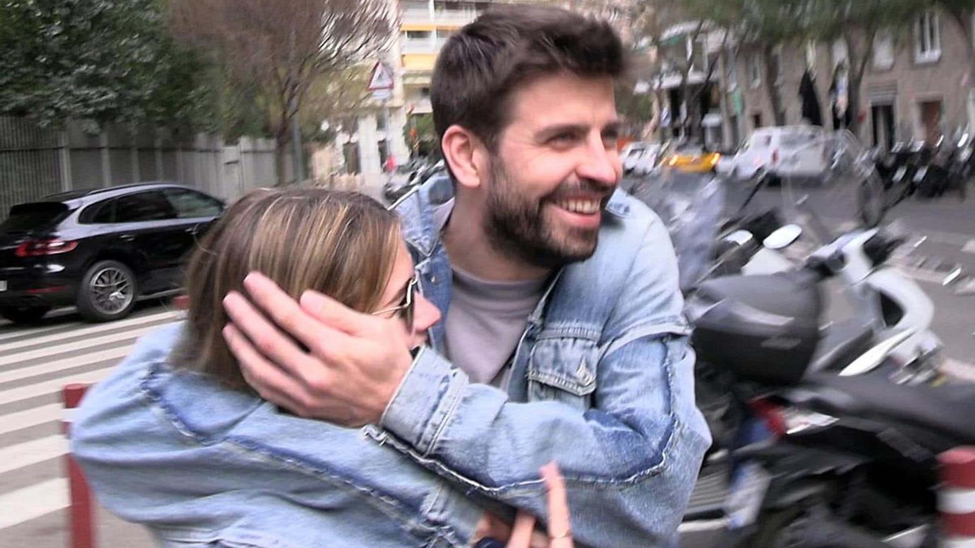 Gerard Piqué and Clara Chia laugh out loud after she hits herself with an advertising sign trying to hide from a paparazzi