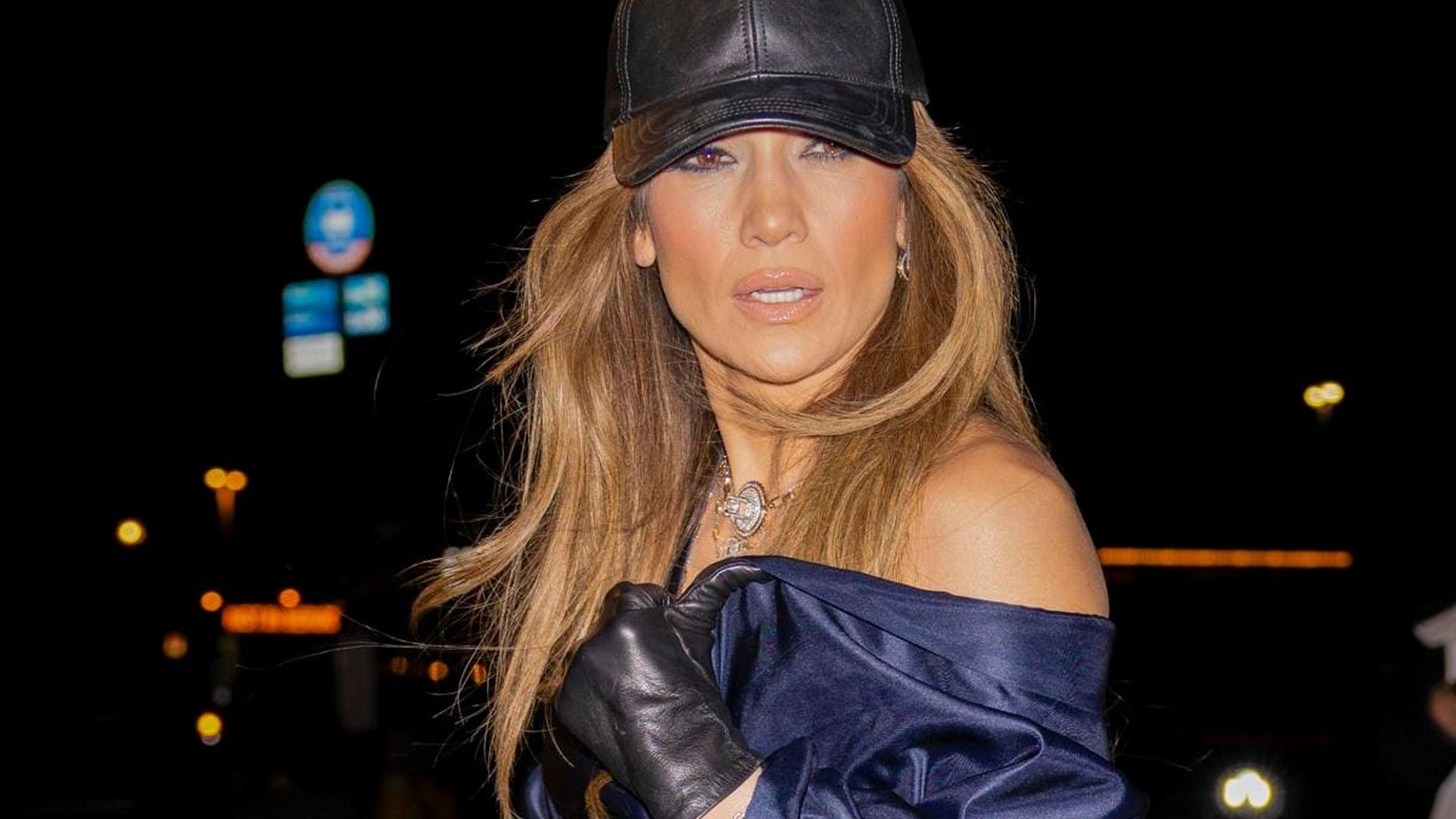 Jennifer Lopez wears dramatic satin jumpsuit and diamond necklace at The Bronx