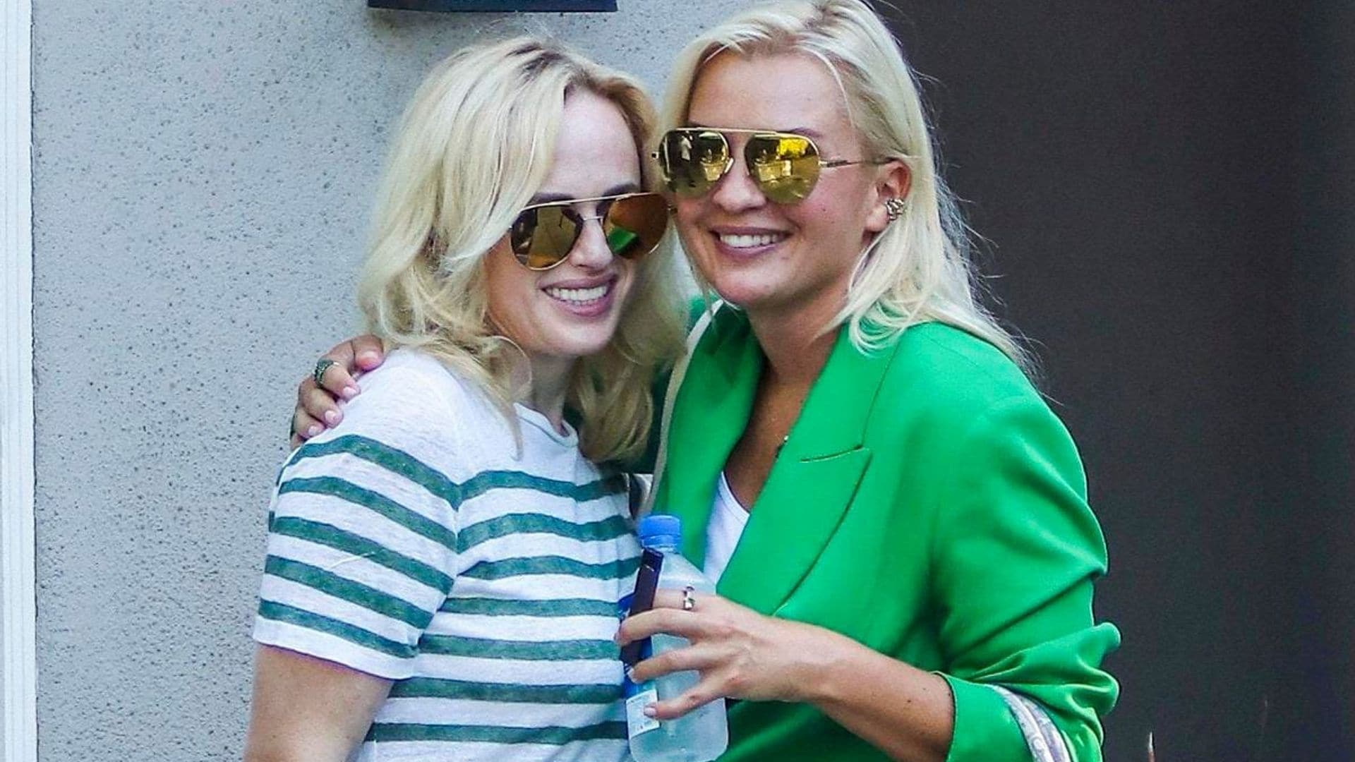 Rebel Wilson & girlfriend Ramona Agruma hold hands in an LA event