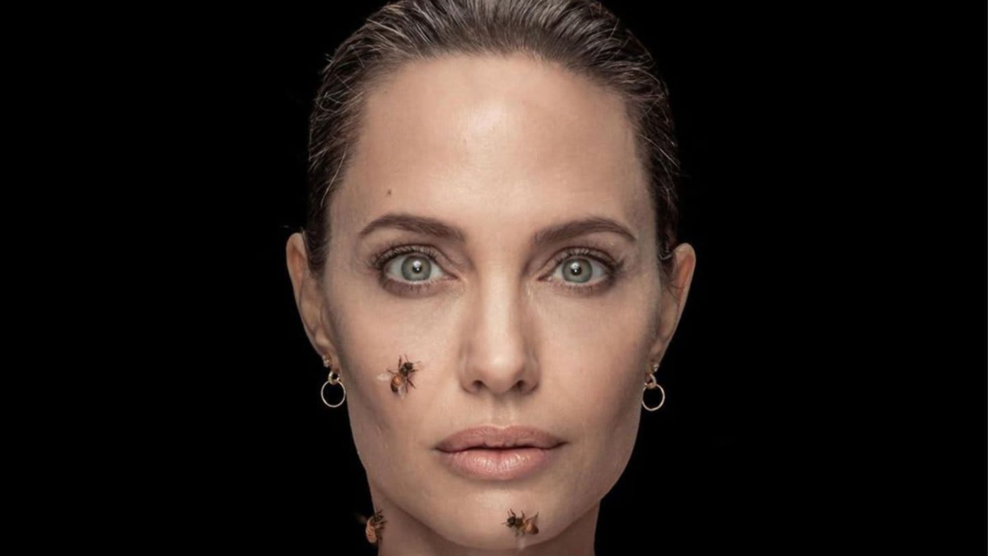 Angelina Jolie poses while covered in bees to raise awareness for conversation efforts