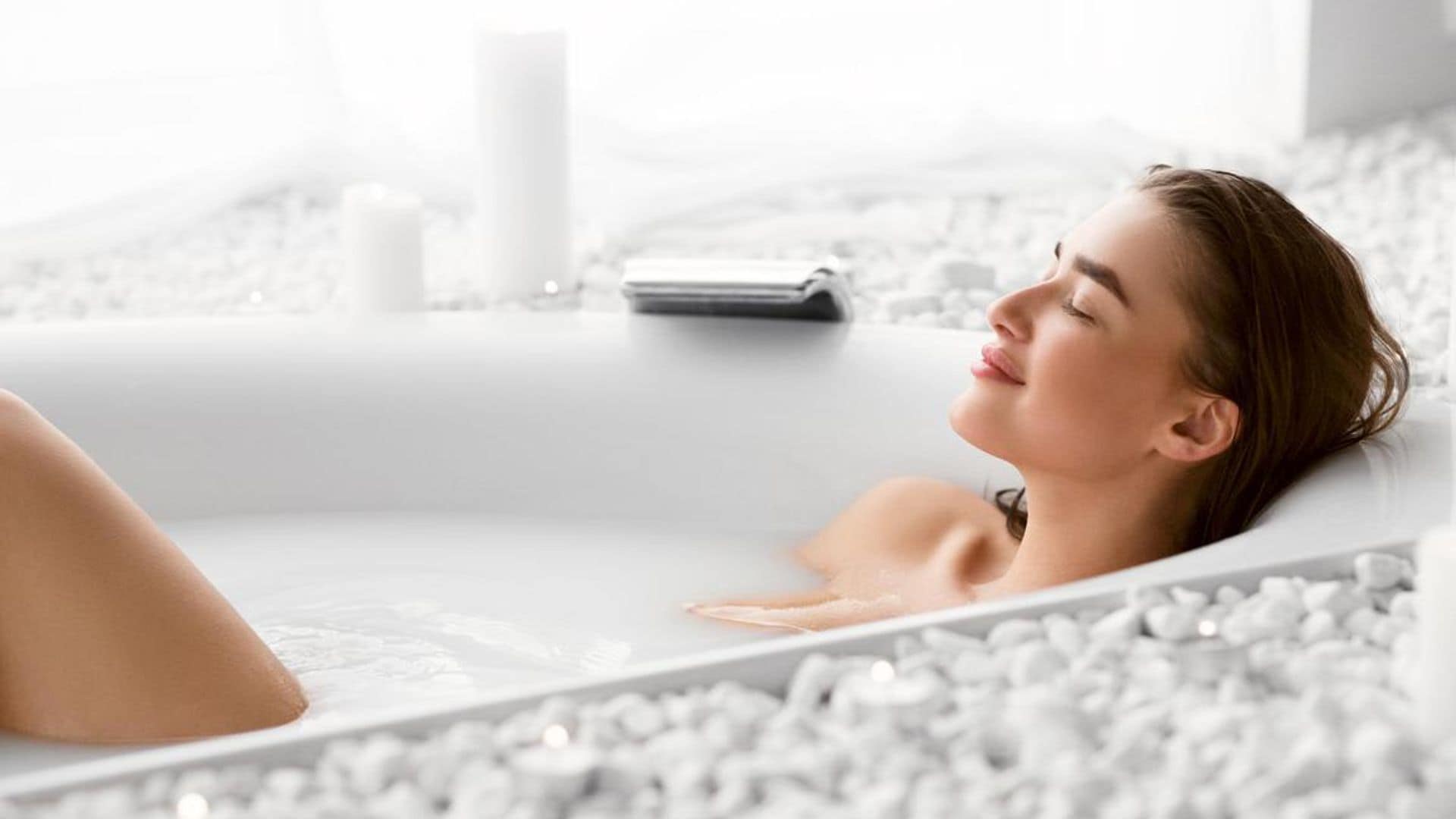 Relaxed, happy woman taking a hot bath