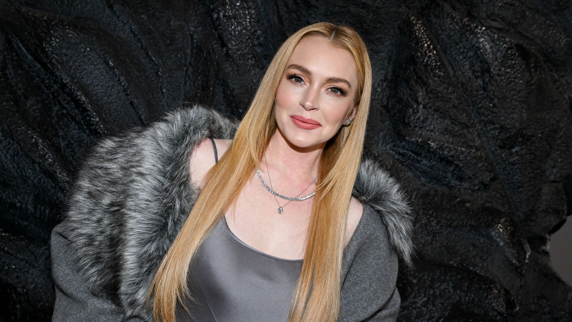 Lindsay Lohan looks stunning in satin slip dress and diamond jewelry at NYFW