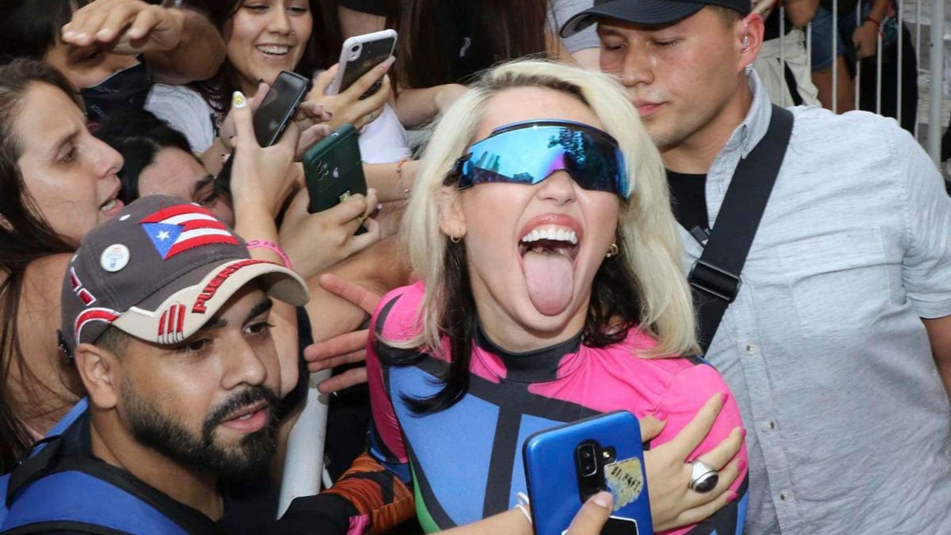 Miley Cyrus poses and takes selfies with fans as hundreds filled the streets in Argentina for her arrival