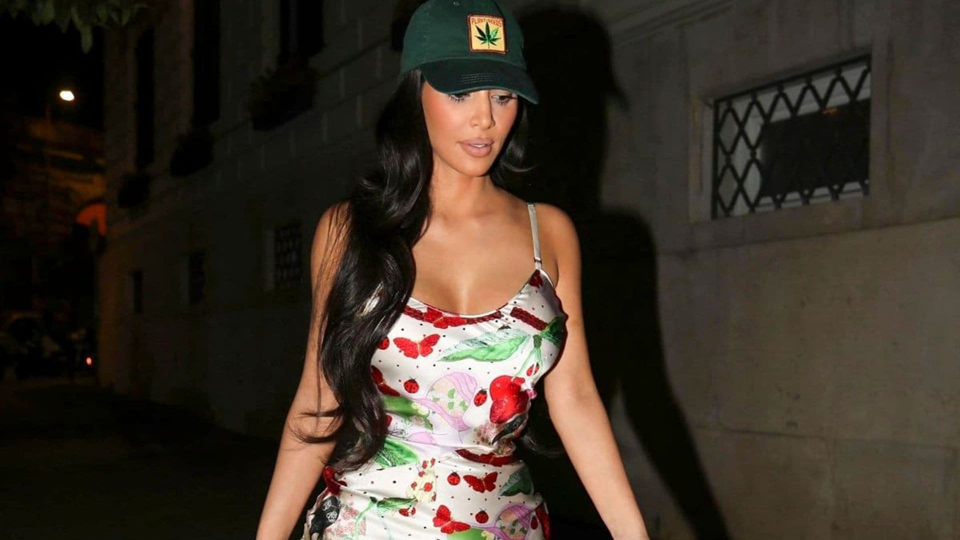 Kim Kardashian rocked a cherry-printed minidress and trucker hat for a night out in Rome