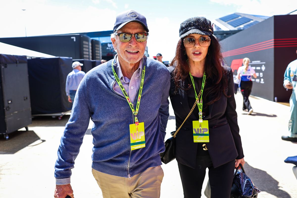 Michael Douglas and Catherine Zeta-Jones walk in the paddock during the F1 Grand Prix of Great Britain at Silverstone Circuit on July 7, 2024