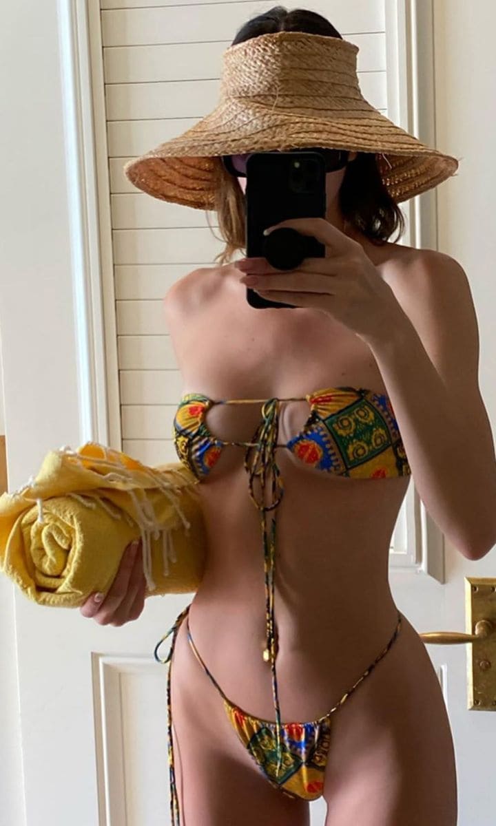 Kendall Jenner posing in a bikini and a hat