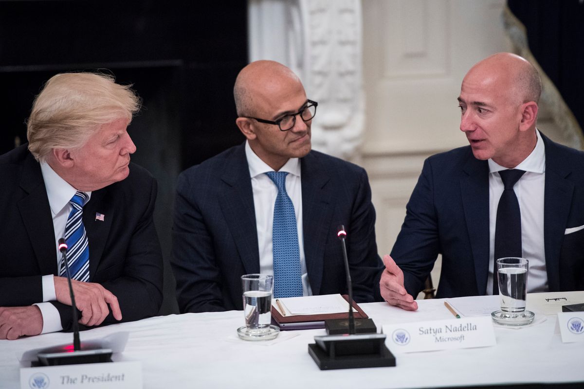 President Donald Trump speaks with Satya Nadella, Chief Executive Officer of Microsoft, and Jeff Bezos, Chief Executive Officer of Amazon during an American Technology Council roundtable in the State Dinning Room at the White House in Washington, DC on Monday, June 19, 2017. (Photo by Jabin Botsford/The Washington Post via Getty Images)