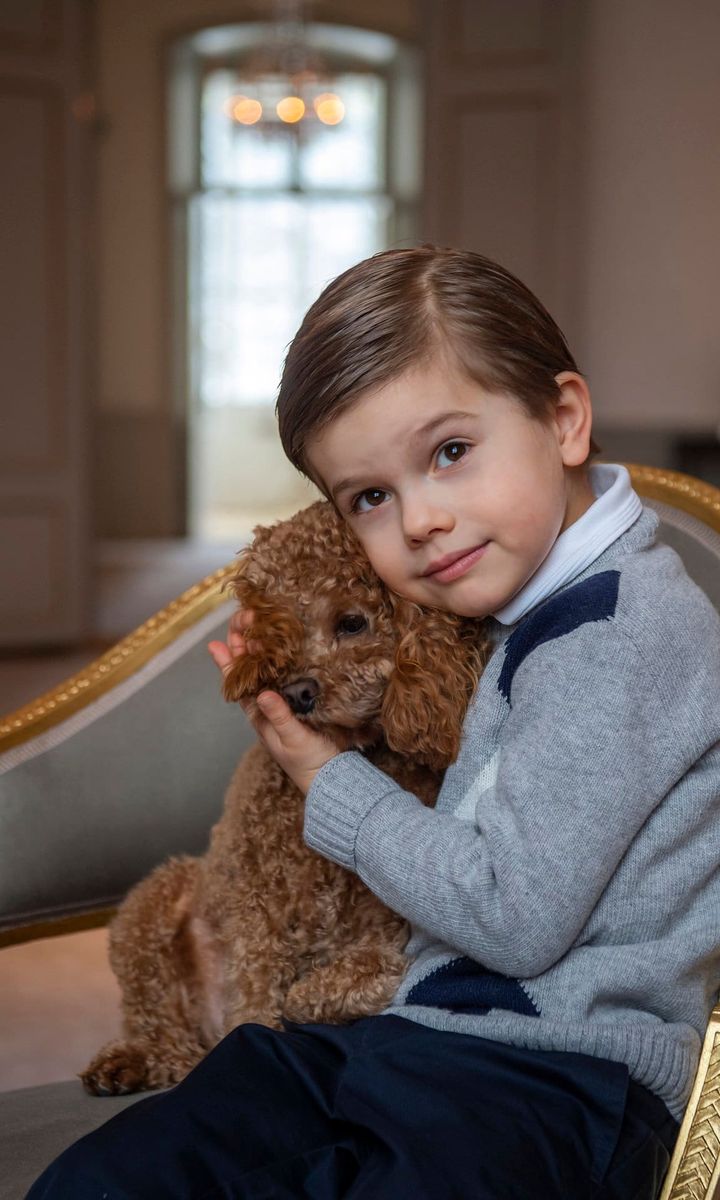 The young Prince cuddled his family’s dog Rio in one photo