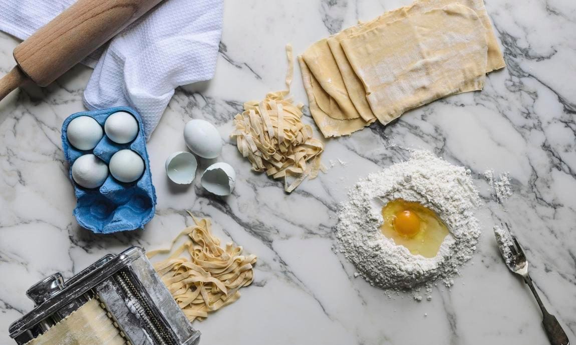 Ingredients and kitchen utensils for homemade pasta (top view)