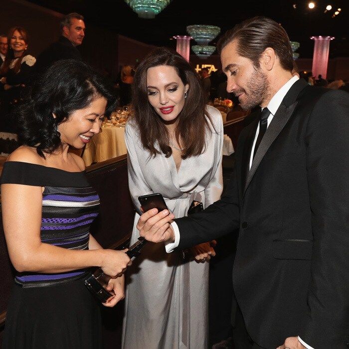 Jake Gyllenhaal showed Angelina Jolie and her producing partner Loung Ung something captivating on his cell during the Hollywood Film Awards. During the event, the mom-of-six and Loung accepted the Hollywood Foreign Language Film Award from inside the Beverly Hilton.
Photo: Getty Images