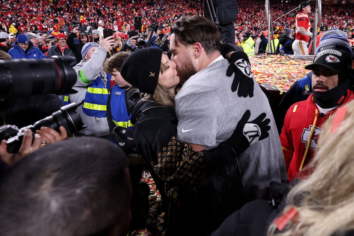 Swift and Kelce kissing on the field