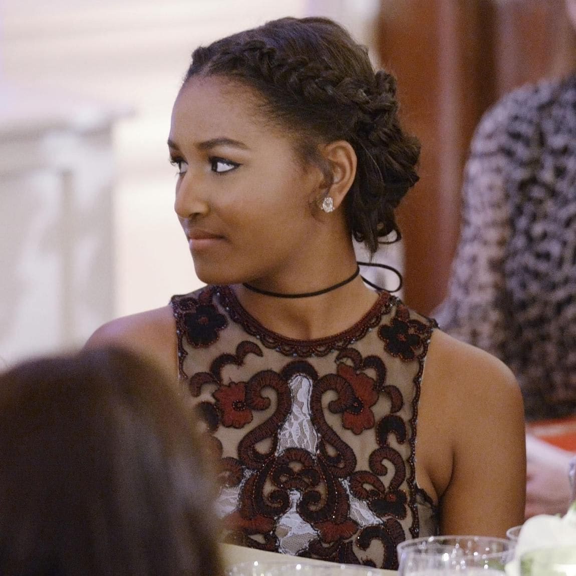 Sasha Obama braided updo, chignon and burgundy dress for state dinner