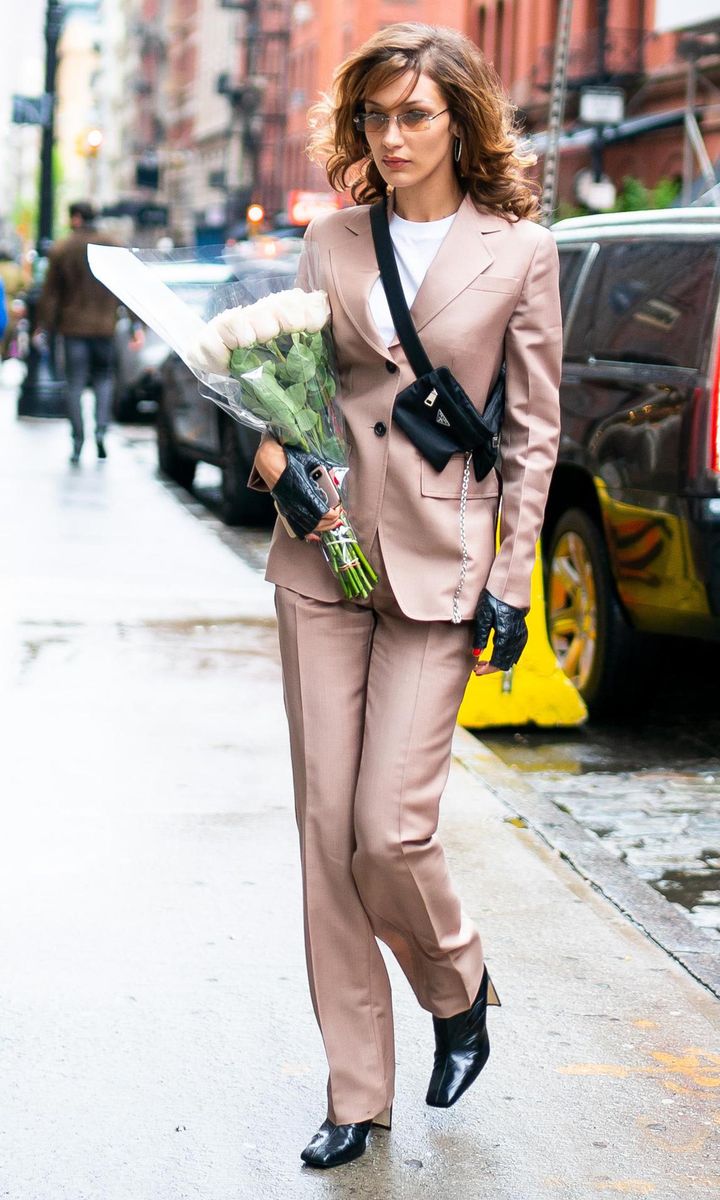 Bella Hadid in a suit with leather gloves