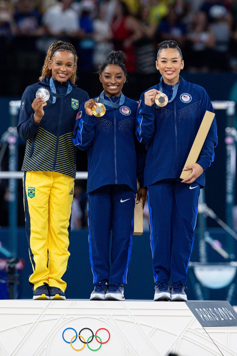 Gold medalist Simone Biles of Team United States (C), Silver medalist Rebeca Andrade of Team Brazil (L), and Bronze medalist Sunisa Lee of Team United States (R) pose on the podium during the Artistic Gymnastics Women's All-Around Final medal ceremony on day six of the Olympic Games Paris 2024 at Bercy Arena on August 01, 2024 in Paris, France. (Photo by Rodolfo Buhrer/Eurasia Sport Images/Getty Images)