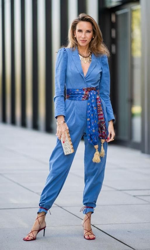 Alexandra Lapp in a jumpsuit and ankle strap sandals tied over the bottom of her pants