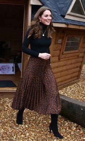 Kate Middleton wearing a black turtleneck sweater and Zara skirt