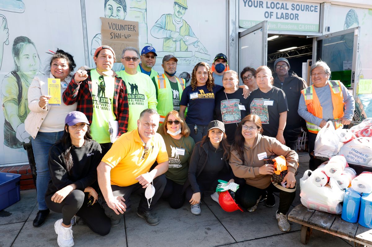 Eva Longoria taking a photo with volunteers and laborers working on the LA fires recovery efforts