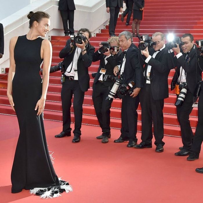 Lights, camera, pose! Model Irina Shayk flashed a smile for the cameras on <i>The Unknown Girl</i> red carpet.
<br>
Photo: LOIC VENANCE/AFP/Getty Images