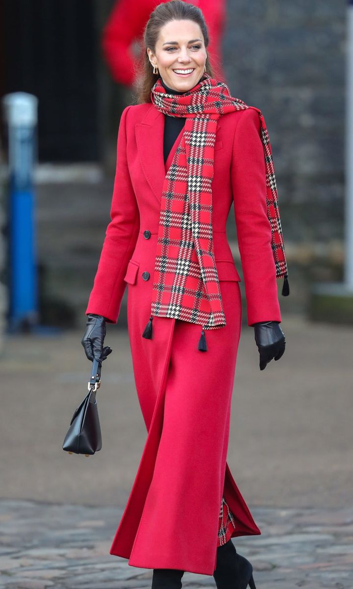 The Duchess looked merry and bright in a red double-breasted Alexander McQueen coat for her first stop of the day in Cardiff.