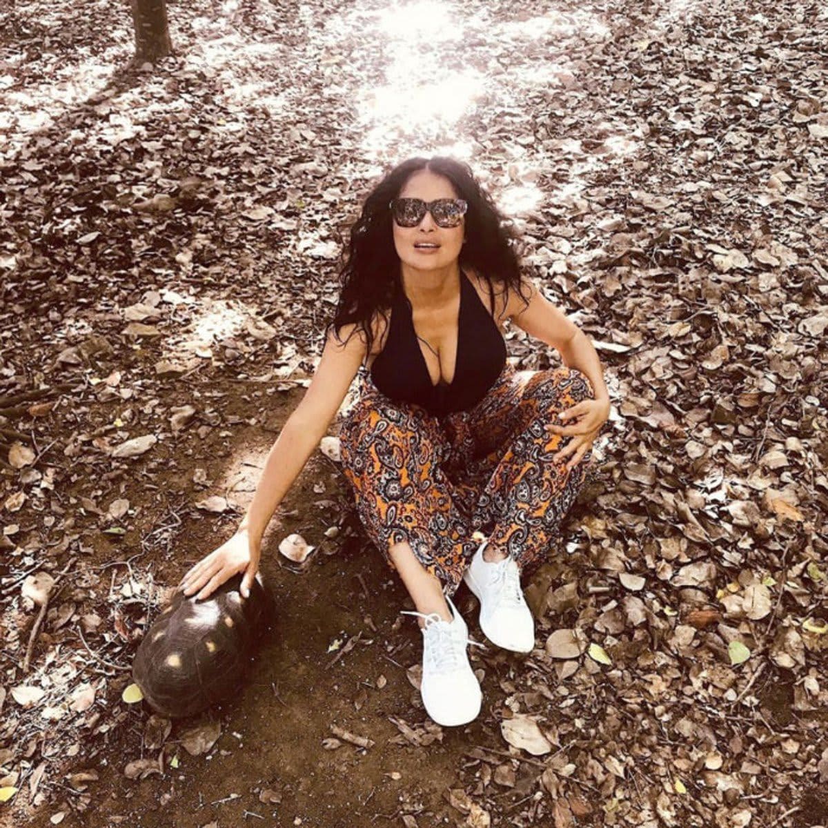 Salma Hayek with a turtle in the woods