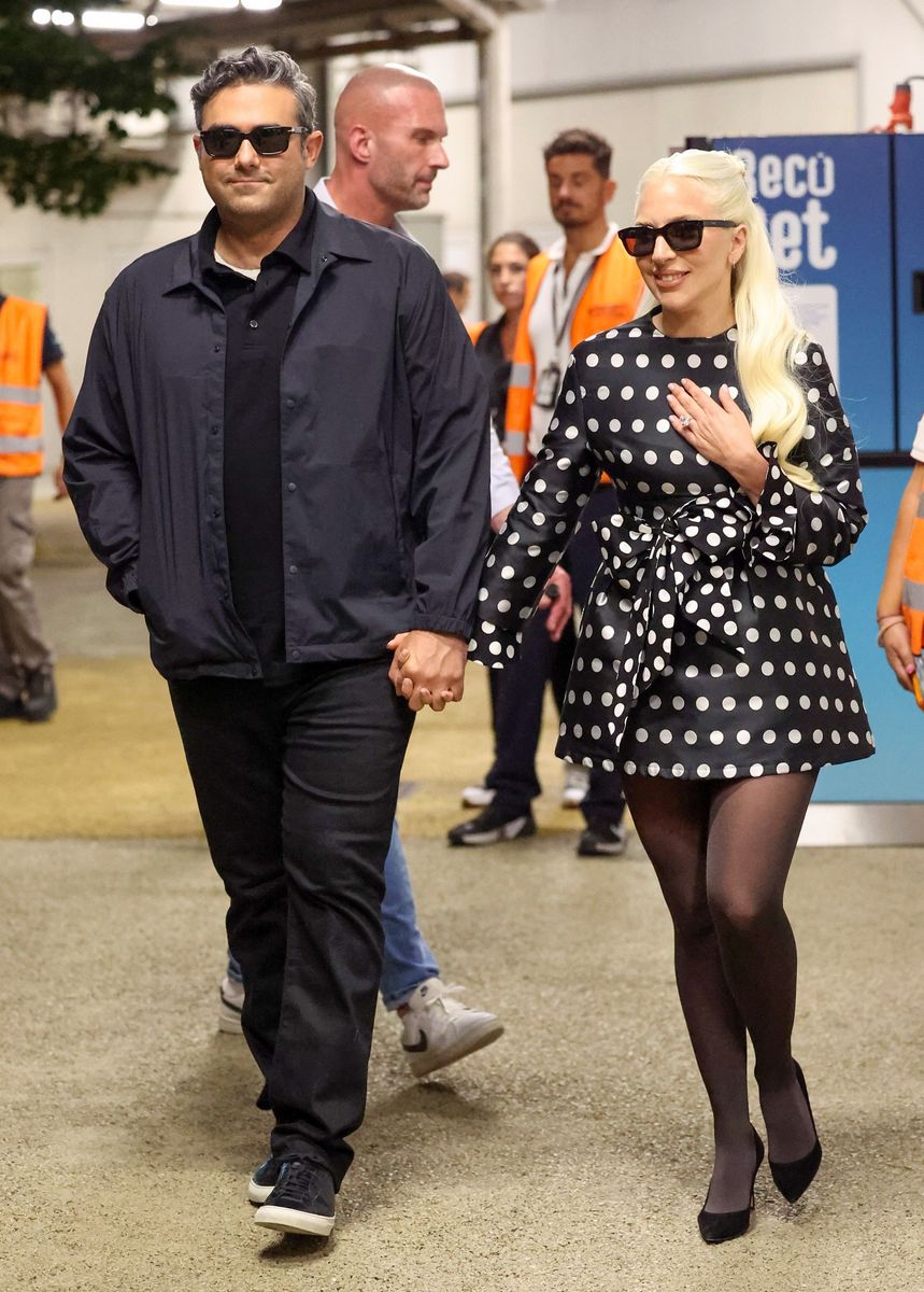 Lady Gaga shows off her engagement ring as she arrives with Michael Polansky at Venice Marco Polo Airport 