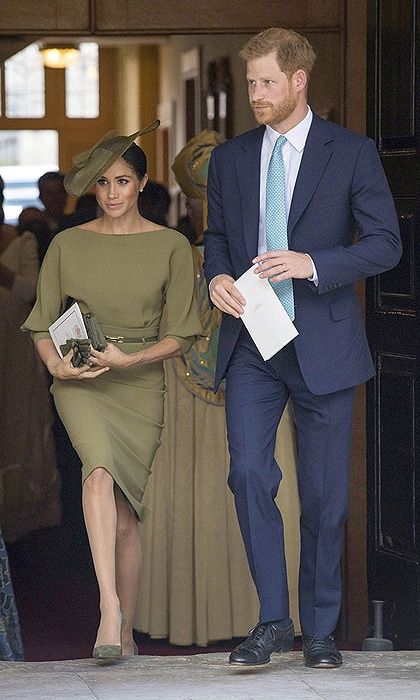 The previous day the proud aunt attended her new nephew Prince Louis' christening alongside Prince Harry championing both of US and British designers, plus suede pumps by Spaniard Manolo Blahnik.
Her olive-green dress, by Ralph Lauren, featured a number of the favoured elements in her new royal uniform: a boat neck, a skinny belt and a figure-skimming silhouette. The royal accessorized the ensemble with a slanted hat by British milliner Stephen Jones, who also designed the white beret she wore on Commonwealth Day, and a matching bag and gloves.
Photo: DOMINIC LIPINSKI/AFP/Getty Images