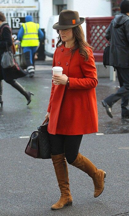 She perfected fall street style in this orange coat, brown suede boots and fedora.
<br>
Photo: Getty Images