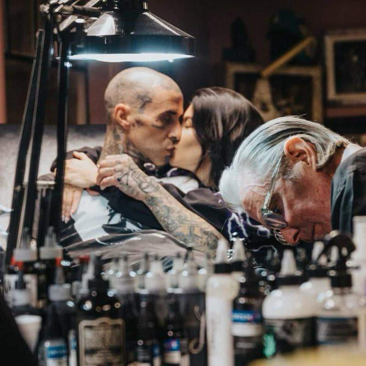 Kourtney Kardashian comforts Travis Barker as he gets a tattoo honoring late Foo Fighters drummer Taylor Hawkins