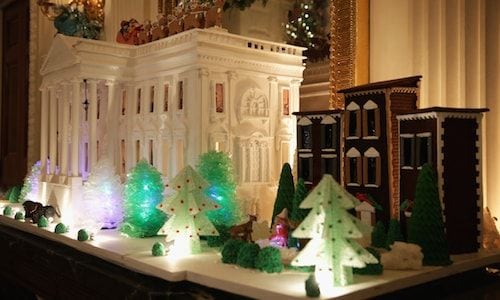 A gingerbread version of the White House is complete with a festive front lawn.