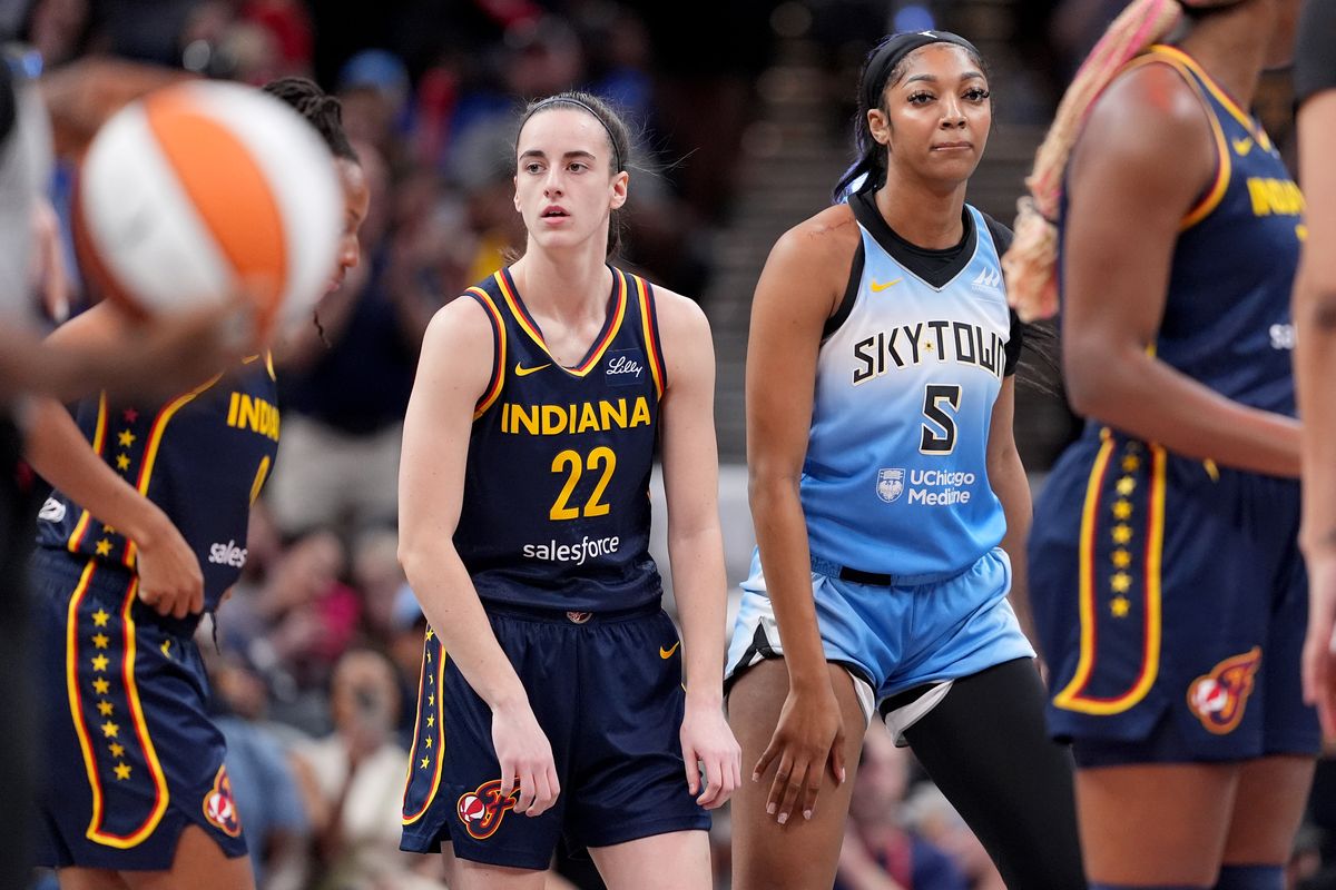 Caitlin Clark #22 of the Indiana Fever and Angel Reese #5 of the Chicago Sky look on during a game at Gainbridge Fieldhouse on June 16, 2024, in Indianapolis, Indiana. 