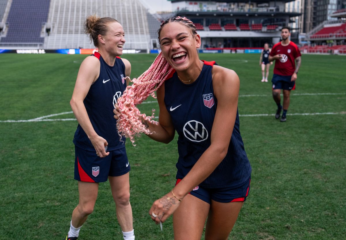 Emily Sonnett and Trinity Rodman of the United States laugh after a USWNT training session at Audi Field on July 15, 2024, in Washington, DC.