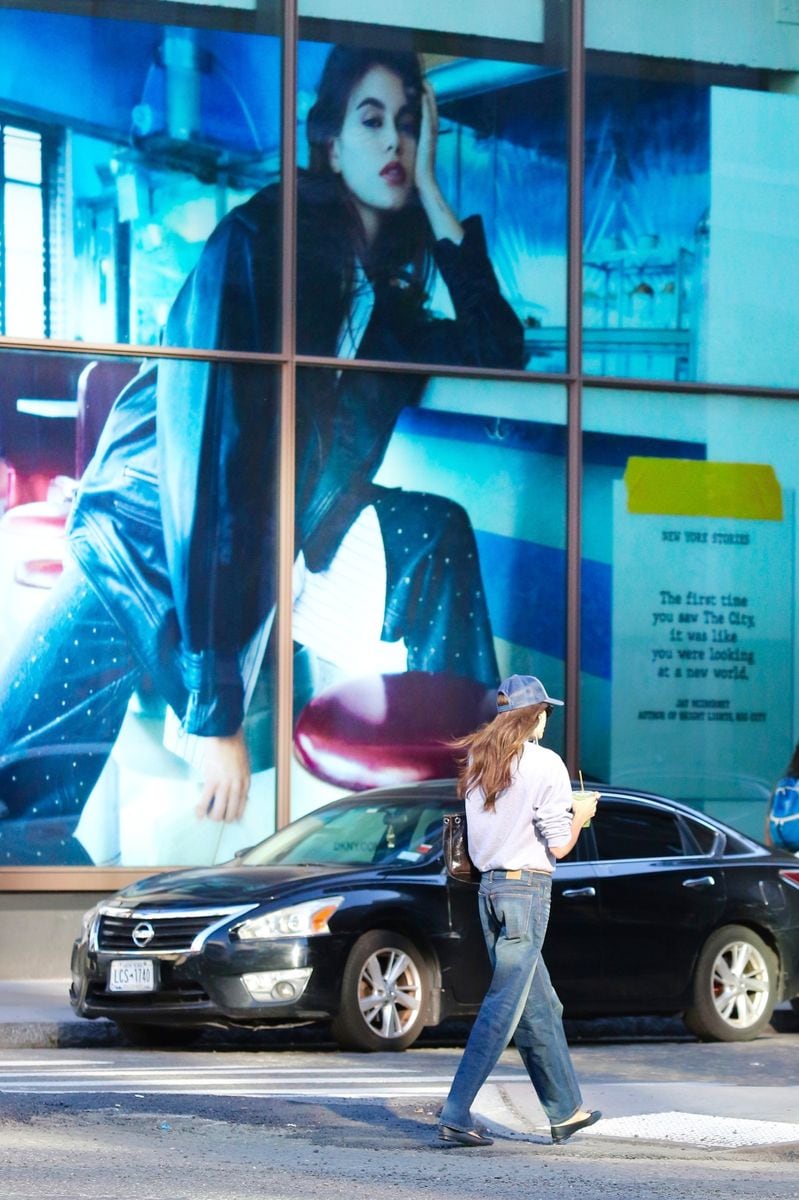 The model seemed unbothered when she walked b the billboard