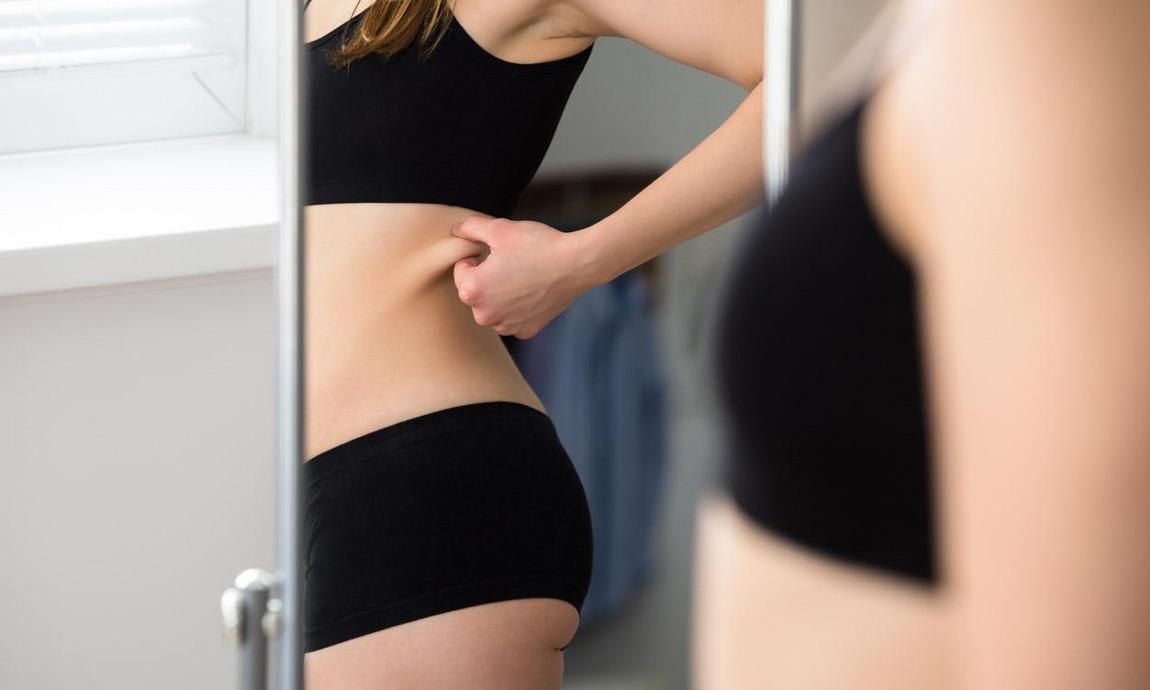 Woman looking at herself in the mirror