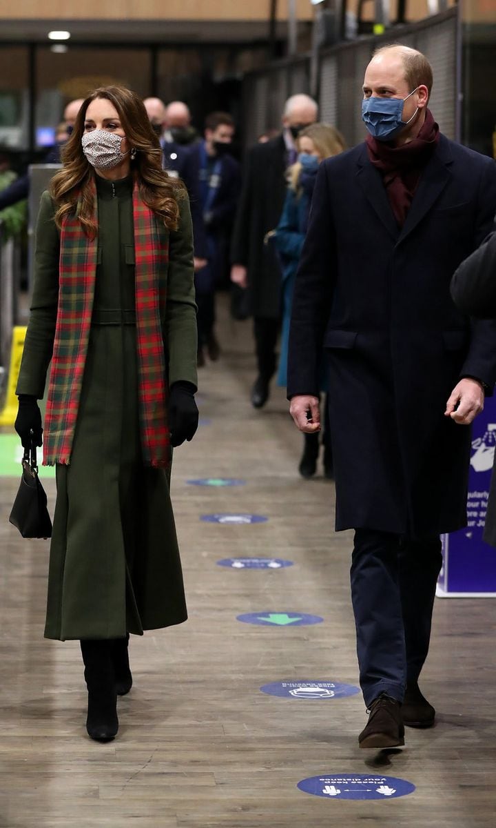 Kate looked holiday-ready for her first time on the Queen's train recycling her green Alexander McQueen coat, which she paired with a tartan scarf.