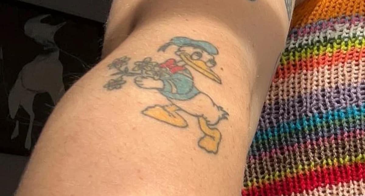 Donald Duck on her right arm