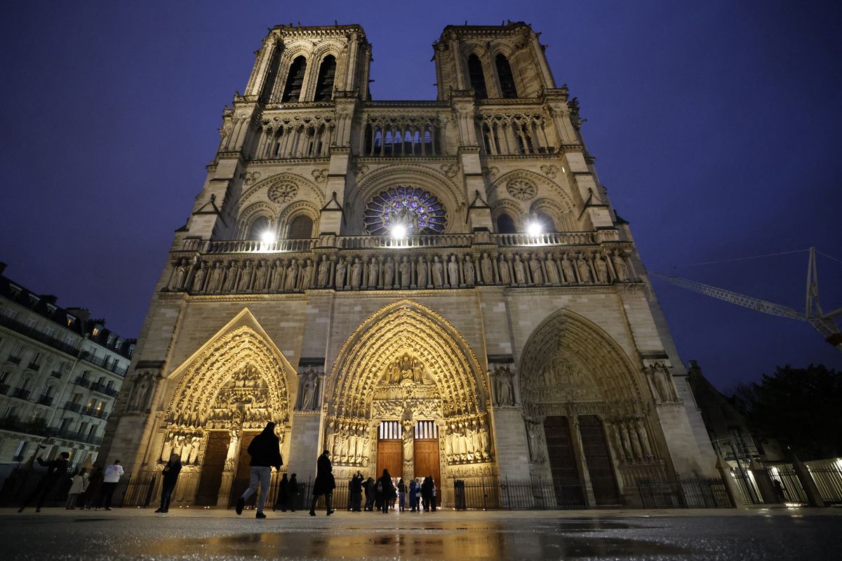  TOPSHOT - People arrive to attend a second mass, open to the public, at the Notre-Dame de Paris cathedral on the day of its re-opening, in Paris on December 8, 2024. Newly restored Notre Dame cathedral held its first mass in the morning, with Christians celebrating the return of the French capital's most famous place of worship after a historic re-opening ceremony. 2,500 people who secured free tickets this week are expected to attend the mass. The cathedral will open fully to visitors on December 16, 2024 via an online reservation system. (Photo by Ludovic MARIN / AFP) (Photo by LUDOVIC MARIN/AFP via Getty Images)