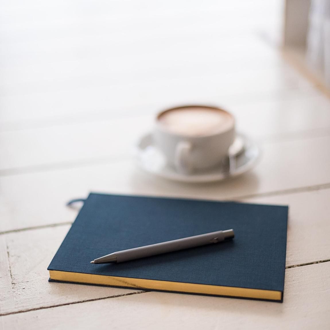 Notebook with coffee cup