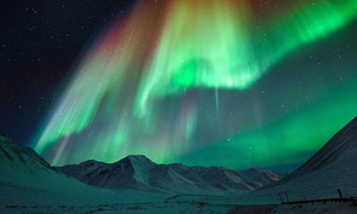 Aurora borealis and snow-capped mountains