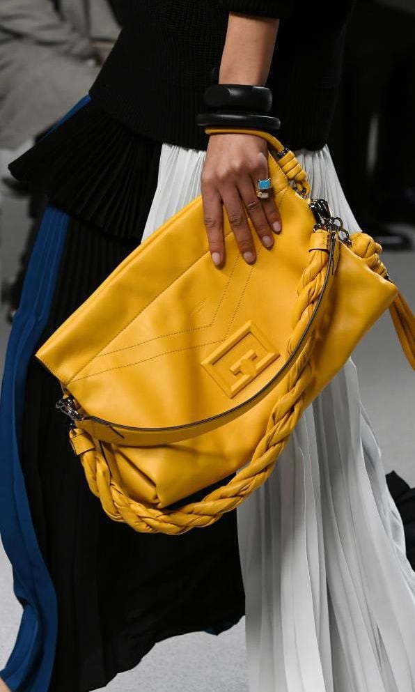 Yellow leather maxi clutch at the Givenchy fashion show