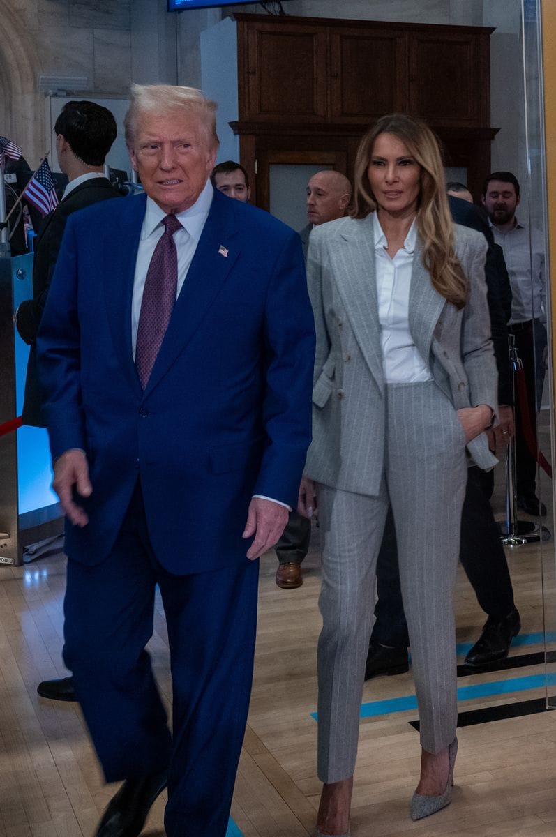 President-elect Donald Trump walks onto the floor of the New York Stock Exchange with his wife Melania.