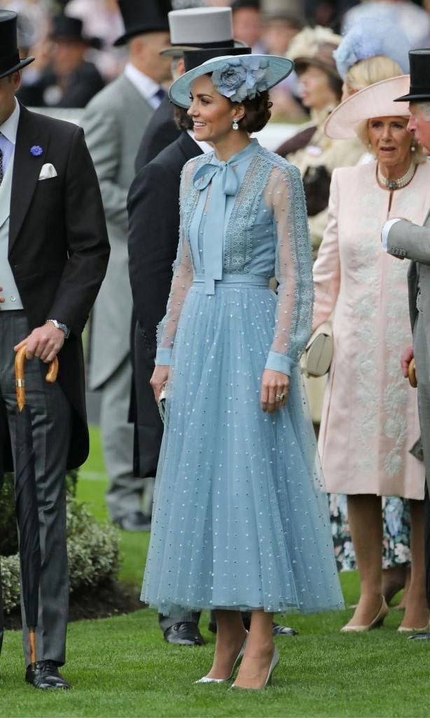 Kate Middleton wearing a baby blue dotted mesh midi dress with a pussycat bow