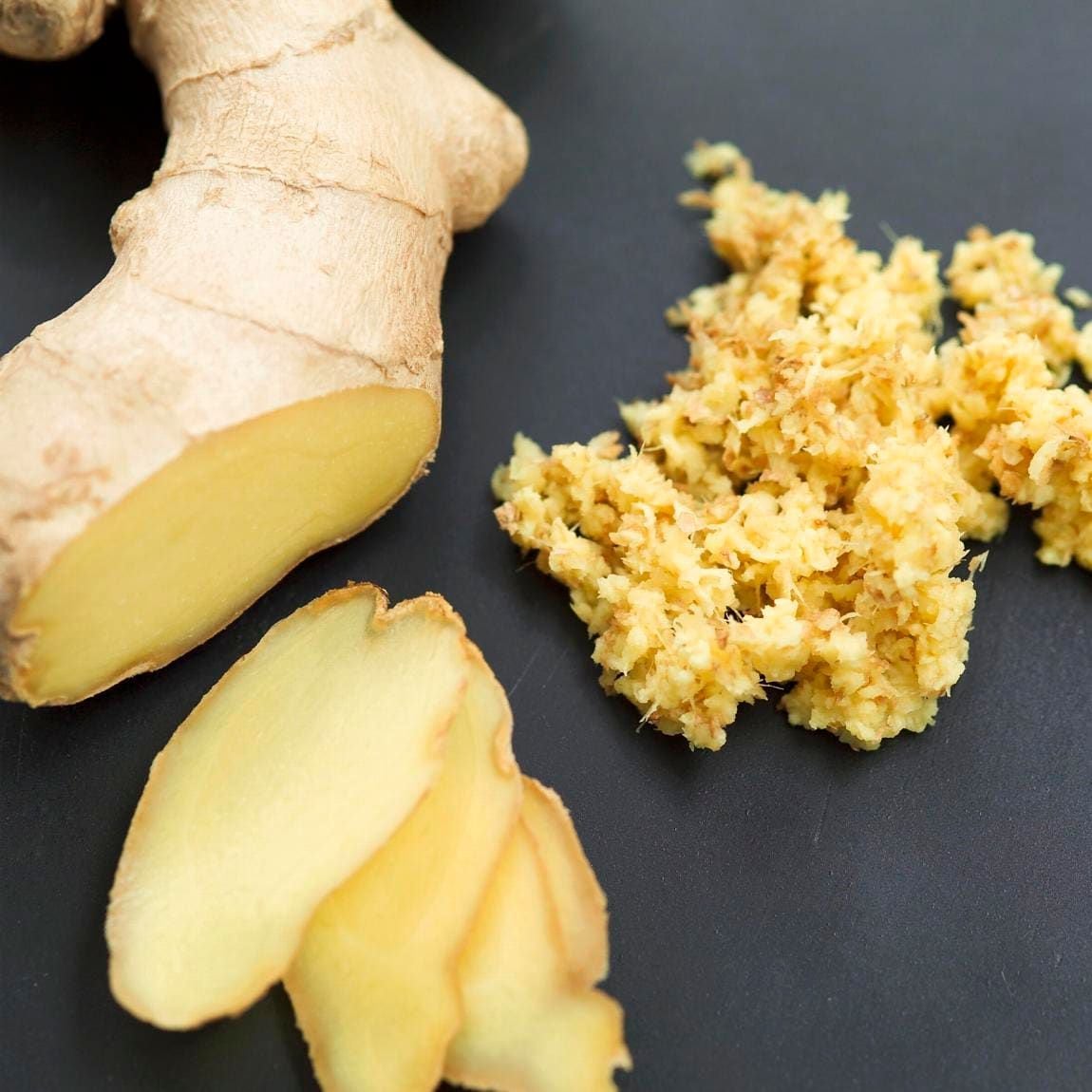 Fresh ginger root in slices and grated