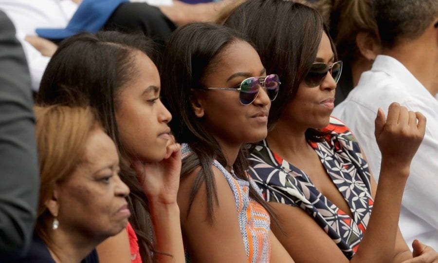 <b>4. She's her daughters' style inspiration</b>
While Michelle told <I>Essence</I>, "I tend not to worry about the trends, because what works for an 18-year-old selfie queen may not for a 52-year-old First Lady who is a mom of teenagers", she and her daughters have been known to rock similar styles. During a trip to Cuba, seen here, Michelle and Sasha wore identical pairs of aviator sun shades.
Photo: Getty Images