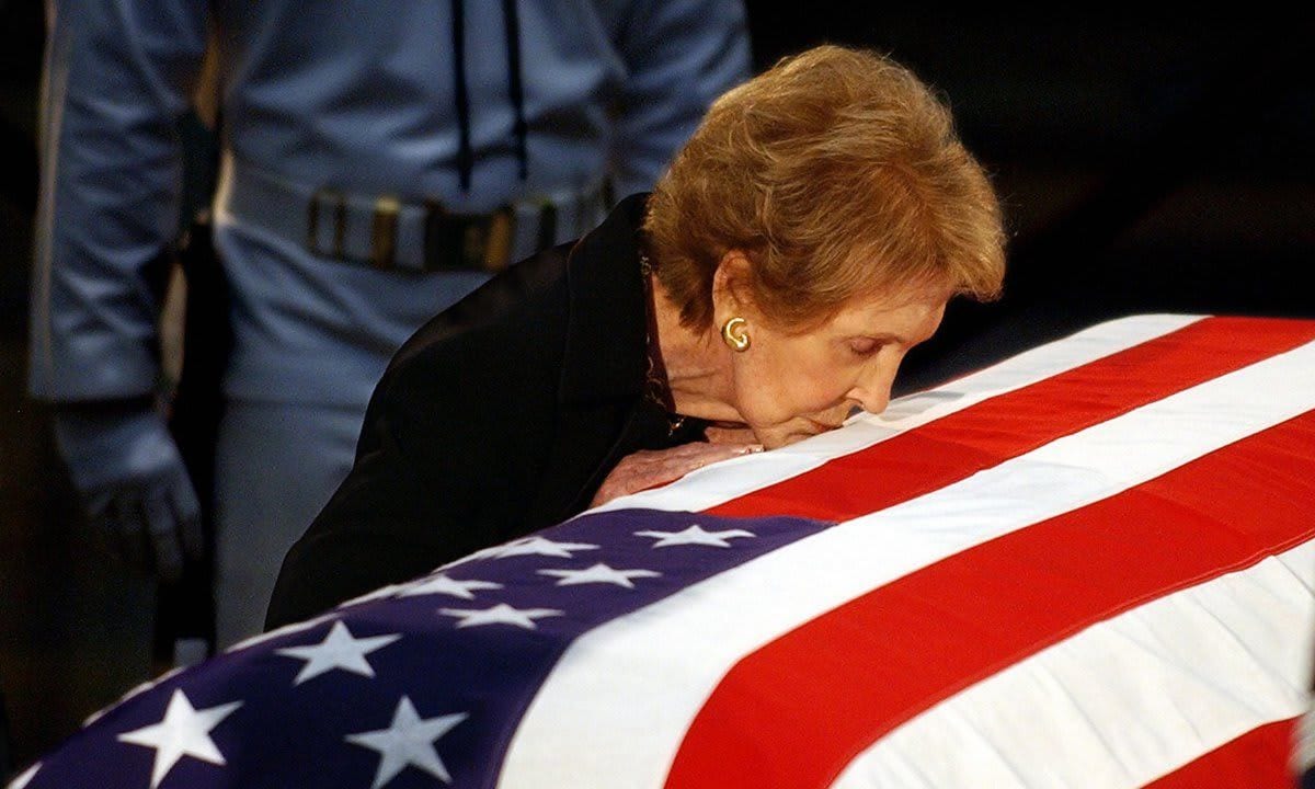 Nancy Reagan kisses the casket containin