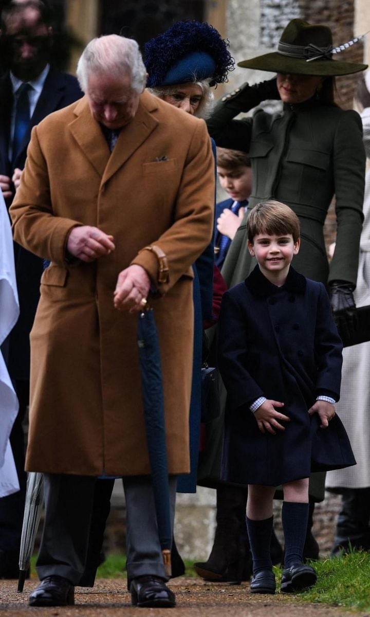 Prince Louis flashed a smile behind his grandfather, King Charles