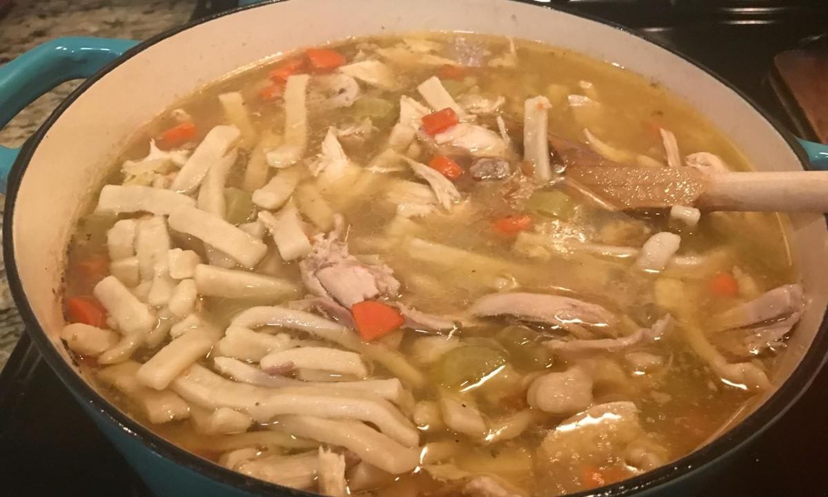 Homemade chicken soup on the stove top