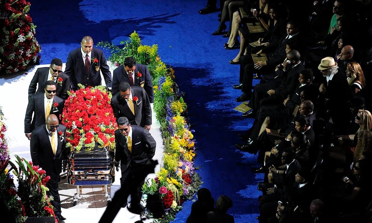 Pallbearers carrying Michael Jackson's coffin leave Staples center stage after memorial, July 7, 2009