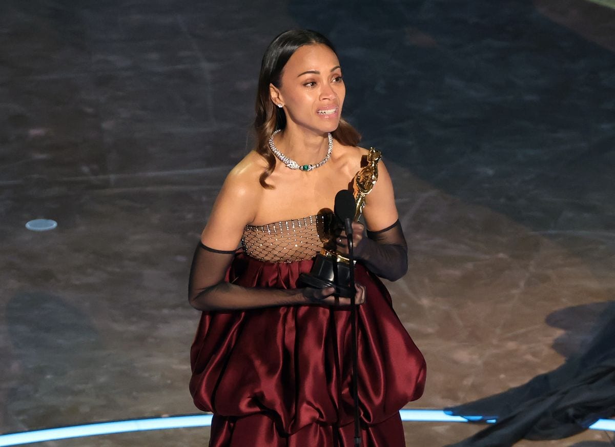 Zoe Saldana accepts the Best Actress In A Supporting Role award Emilia Perez