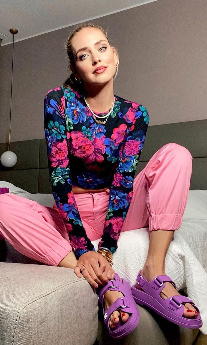 Chiara Ferragni wearing lilac Chanel dad sandals, pink pants, and a floral sweater